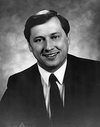 A black and white photo of Provo's former mayor James Eldon Ferguson wearing a suit and smiling
