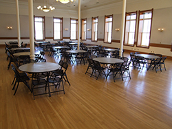 A banquet style setup with round tables and chairs in the ballroom at the Provo City Library